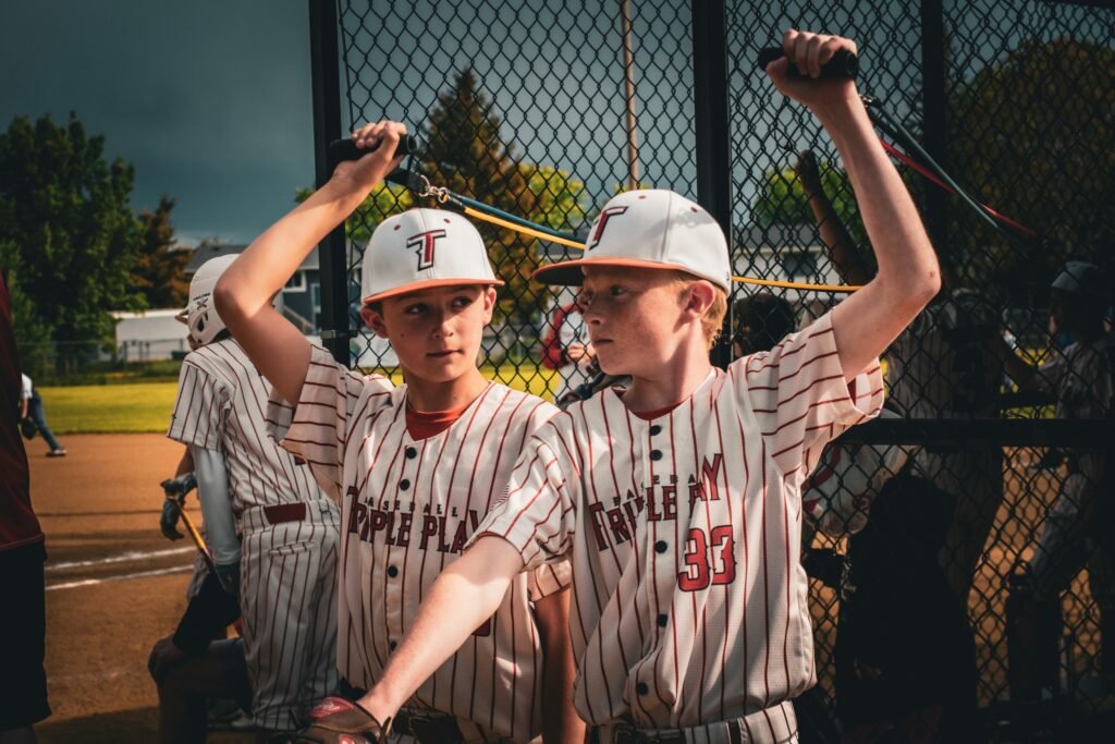 Little League Baseball players warming up to play.
