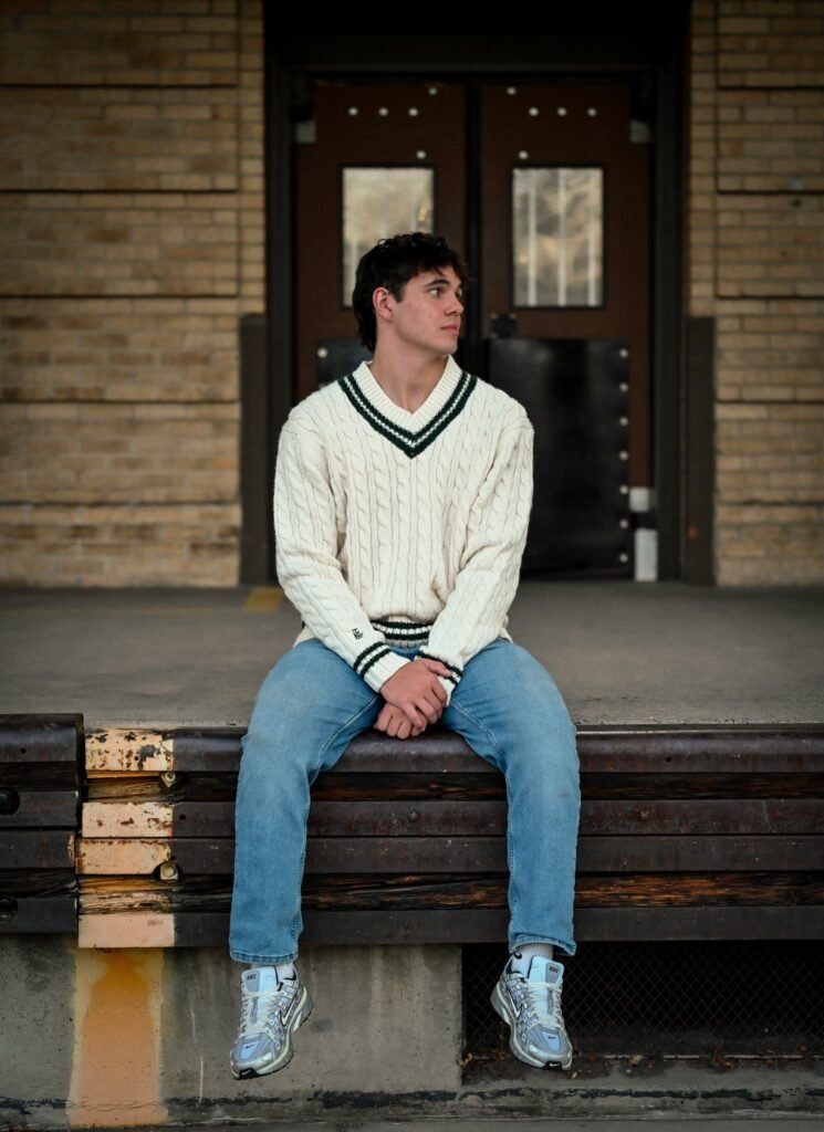 A boy seated on a loading dock.
