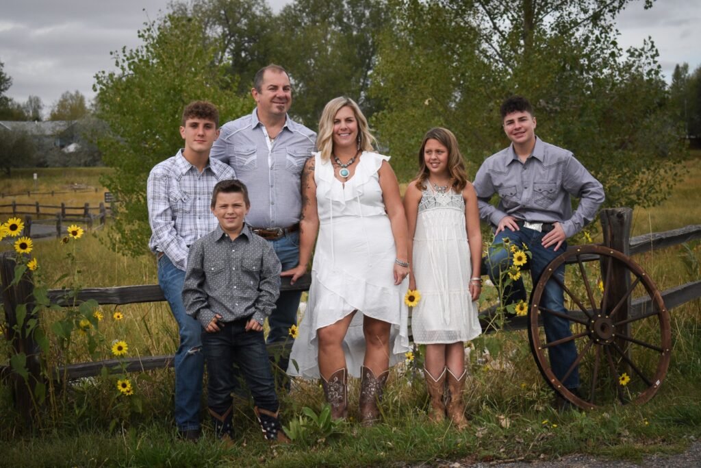 A woman poses with husband,  daughter and three sons.