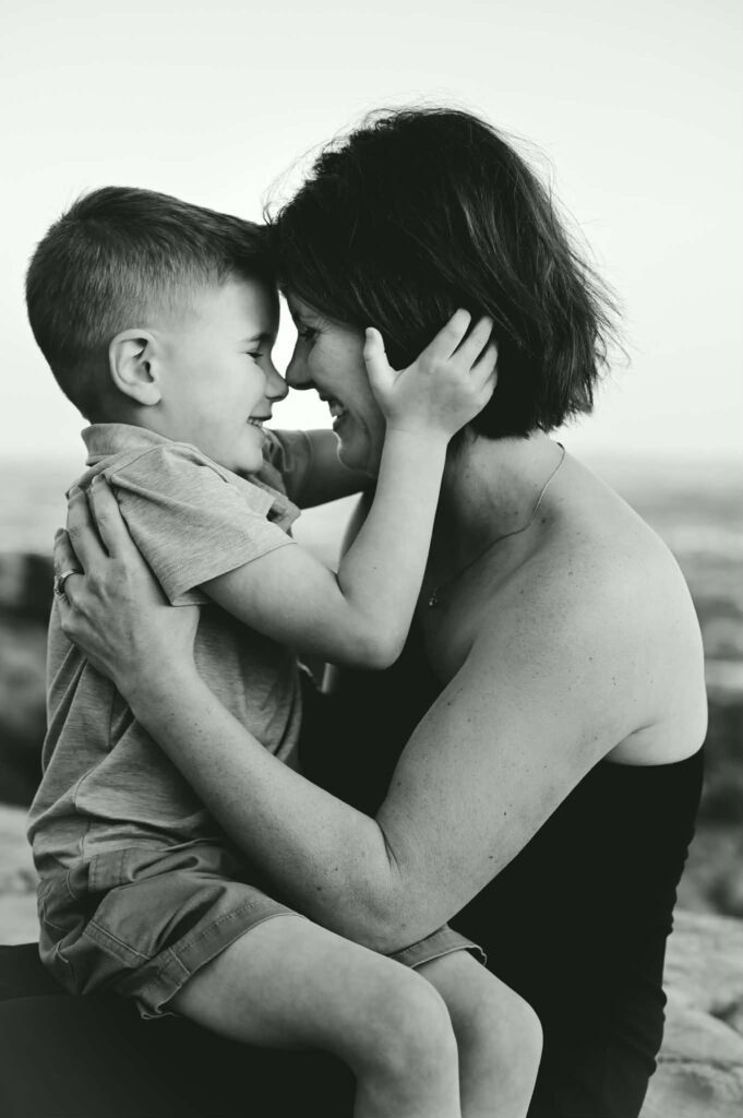 A black and white photo of a young mother and her little boy.